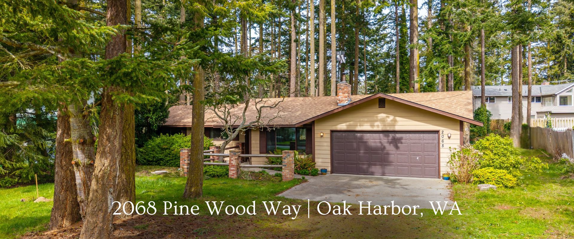 4-bedroom home for sale in Oak Harbor’s West Beach area with large wooded lot, fireplace, and two-car garage near coastal parks.