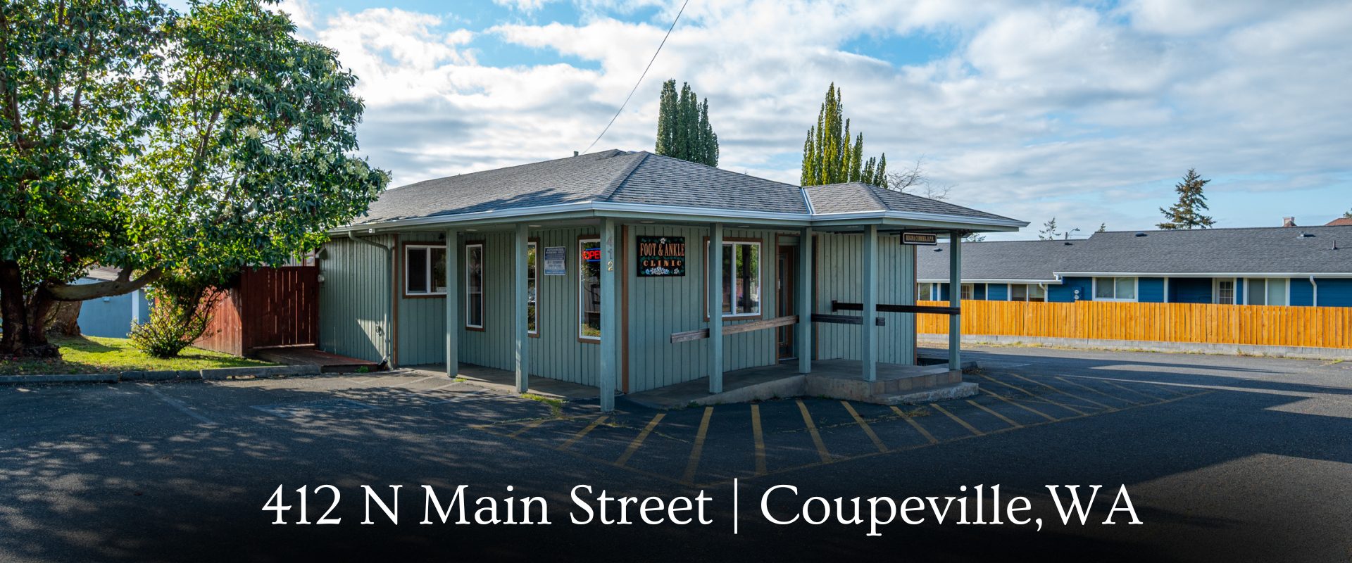 xterior view of the professional medical office building at 412 N Main Street in Coupeville, WA, highlighting the private parking lot and ramp entrance.