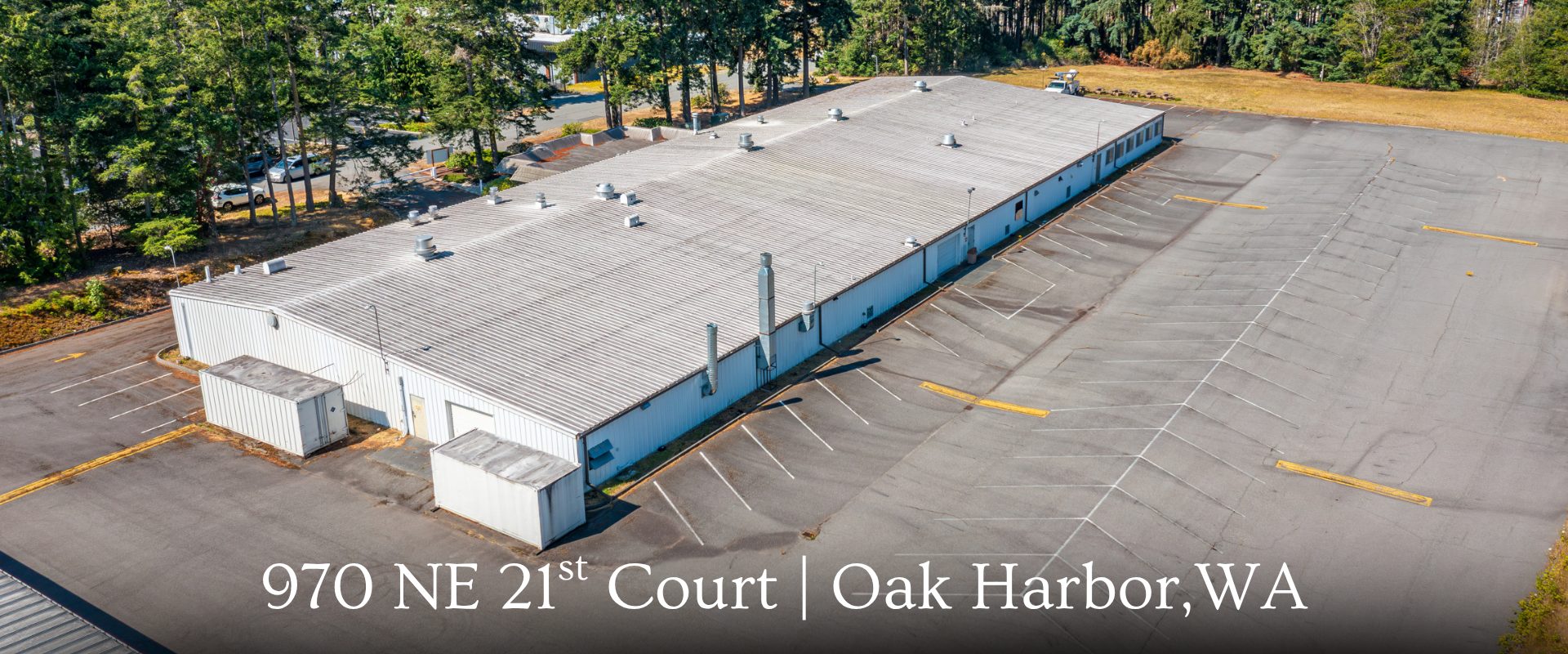 "Aerial view of the industrial building for lease at 970 NE 21st Court in Oak Harbor, WA, represented by Tyler Fitzgerald and Team."